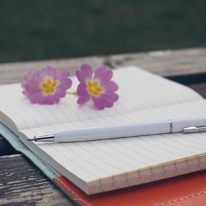 notepad, pen and flowers